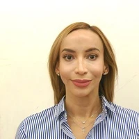 HeadshotPro’s published input: a woman in a striped shirt against a pale wall